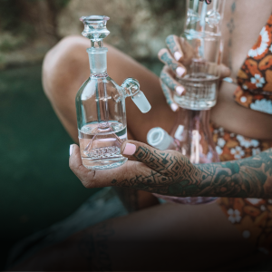 Woman holding a Showerhead Ash Catcher along with a Higher Concepts Cone Piece