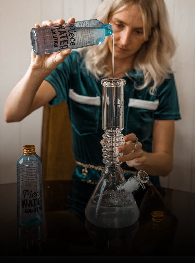 Woman pouring Piece Water Solution into glass beaker bong