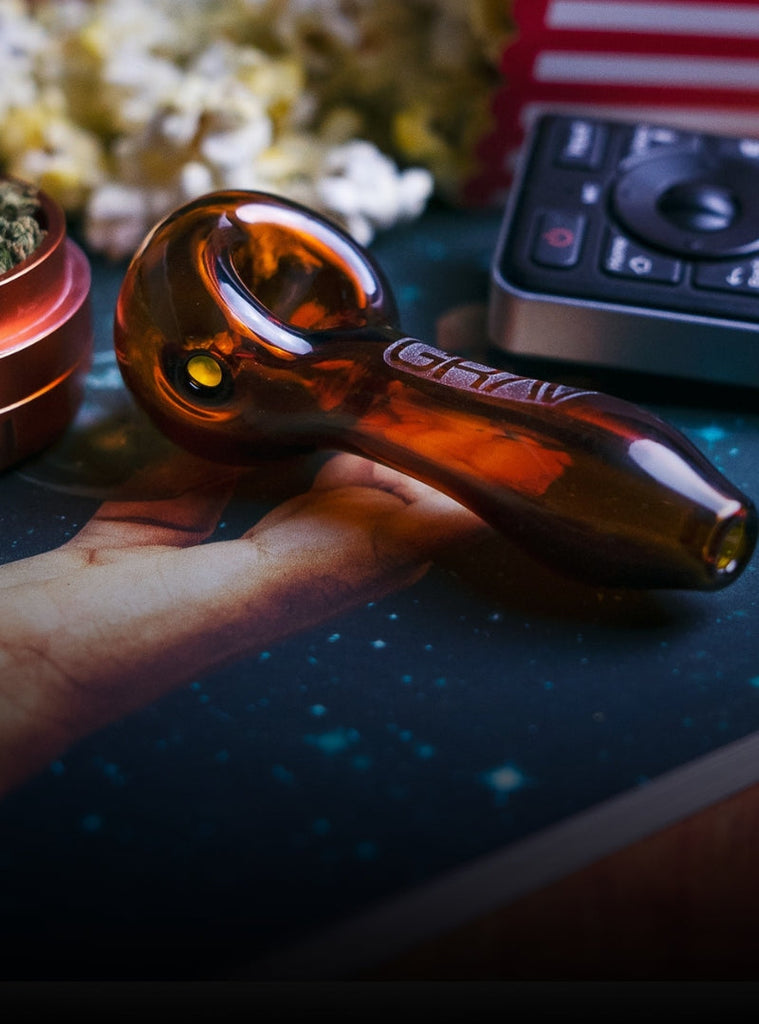 A GRAV hand held glass spoon pipe on a table