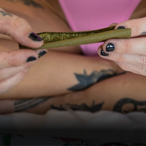 Woman rolling a hemp wrap with cannabis using two hands